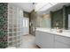Bathroom with glass block shower, updated vanity, and tropical wallpaper at 5480 Sea Edge Dr, Punta Gorda, FL 33950
