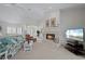 Living room with fireplace, comfortable seating, and large windows at 5480 Sea Edge Dr, Punta Gorda, FL 33950