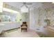 Bathroom with walk-in shower, soaking tub, and floral wallpaper at 5480 Sea Edge Dr, Punta Gorda, FL 33950