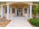 Elegant front door entry with arched entryway and columns at 5480 Sea Edge Dr, Punta Gorda, FL 33950