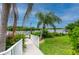Walkway to private dock with lush landscaping at 5480 Sea Edge Dr, Punta Gorda, FL 33950