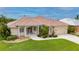 Single-story home with tile roof, landscaping, and a two-car garage at 5480 Sea Edge Dr, Punta Gorda, FL 33950