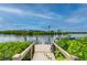 Serene dock with lush landscaping and tranquil water views at 5480 Sea Edge Dr, Punta Gorda, FL 33950