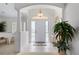 Bright and airy entryway with tiled floor and piano at 5480 Sea Edge Dr, Punta Gorda, FL 33950