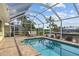 Relaxing screened pool area with patio furniture and canal view at 994 Messina Dr, Punta Gorda, FL 33950