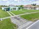 Aerial view of a mid-century modern home with a large yard and neighboring homes at 3107 Easy St, Port Charlotte, FL 33952