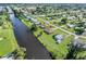 Aerial view of canal-front property with large backyard and single-Gathering home at 3107 Easy St, Port Charlotte, FL 33952