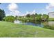 Peaceful view of a canal with lush vegetation and nearby apartments at 3107 Easy St, Port Charlotte, FL 33952