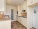 Kitchen with granite counters and white cabinets at 3107 Easy St, Port Charlotte, FL 33952