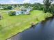 Aerial view of a canal-side home with a spacious yard at 3107 Easy St, Port Charlotte, FL 33952