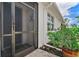 Inviting front entry with a screened door and landscaping at 43614 Sparrow Dr, Punta Gorda, FL 33982