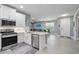 Open concept kitchen with white cabinets and stainless steel appliances at 43614 Sparrow Dr, Punta Gorda, FL 33982