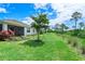 Large backyard with grassy area and mature trees at 43614 Sparrow Dr, Punta Gorda, FL 33982