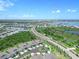Aerial view of community with lake and lush landscaping at 43614 Sparrow Dr, Punta Gorda, FL 33982