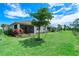 Spacious backyard with screened patio and lush landscaping at 43614 Sparrow Dr, Punta Gorda, FL 33982
