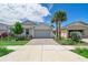 Two-story home with gray garage door and landscaping at 43614 Sparrow Dr, Punta Gorda, FL 33982