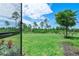 View of backyard through screened door; grassy area at 43614 Sparrow Dr, Punta Gorda, FL 33982