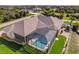 Aerial view of a home with pool and landscaped yard in a residential neighborhood at 14176 Saul Ln, Port Charlotte, FL 33981