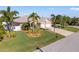 Single-story home with three-car garage and lush landscaping at 14176 Saul Ln, Port Charlotte, FL 33981