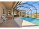 Sparkling pool with a screened enclosure and patio furniture at 14176 Saul Ln, Port Charlotte, FL 33981