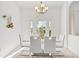 Elegant dining room with white table and chairs, and large windows at 14176 Saul Ln, Port Charlotte, FL 33981