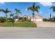 House exterior showcasing curb appeal and palm trees at 14176 Saul Ln, Port Charlotte, FL 33981