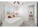 Spacious bedroom with a queen bed, access to another room, and neutral decor at 14176 Saul Ln, Port Charlotte, FL 33981