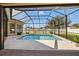 Refreshing screened pool with a view of the backyard at 14176 Saul Ln, Port Charlotte, FL 33981