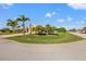 Exterior of home with circular driveway and palm trees at 14176 Saul Ln, Port Charlotte, FL 33981