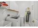 Laundry room with washer, dryer, cabinets, and shelving at 14176 Saul Ln, Port Charlotte, FL 33981