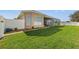 Landscaped backyard with lush grass and white fence at 14176 Saul Ln, Port Charlotte, FL 33981