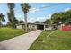 Mid-century modern home with mature landscaping at 1642 Banyan Dr, Venice, FL 34293
