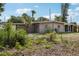 House exterior showcasing rear view and large yard at 1642 Banyan Dr, Venice, FL 34293