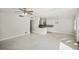 Open living room with a ceiling fan, and a view into the kitchen at 1642 Banyan Dr, Venice, FL 34293