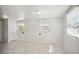 Spacious bedroom with tile flooring and large windows, offering ample natural light at 1642 Banyan Dr, Venice, FL 34293