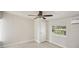 Simple bedroom with ceiling fan and window at 1642 Banyan Dr, Venice, FL 34293