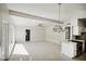 Open living room with kitchen access, and a view to backyard at 1642 Banyan Dr, Venice, FL 34293