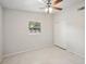 Bright bedroom with ceiling fan, window, and closet at 1642 Banyan Dr, Venice, FL 34293