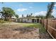 Large backyard with cleared space and wooden fence at 1642 Banyan Dr, Venice, FL 34293