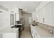 Modern kitchen features white cabinets, stainless steel appliances, and quartz countertops at 1642 Banyan Dr, Venice, FL 34293