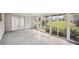Bright sunroom with glass sliders and view of backyard at 1642 Banyan Dr, Venice, FL 34293
