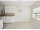 Simple dining area with light flooring and a chandelier at 1642 Banyan Dr, Venice, FL 34293