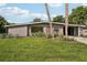 Charming mid-century home with a lush green lawn at 1642 Banyan Dr, Venice, FL 34293