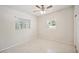 Spacious bedroom with ceiling fan and two windows at 1642 Banyan Dr, Venice, FL 34293