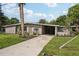 Updated mid-century home with driveway and landscaping at 1642 Banyan Dr, Venice, FL 34293