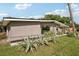 Mid-century modern home with landscaped front yard at 1642 Banyan Dr, Venice, FL 34293