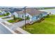 Desirable home in a peaceful community featuring lovely landscaping, a brick driveway, and a picturesque lake view at 1781 W Palms Dr, Port Charlotte, FL 33953