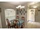 Cozy dining area with light blue table and four wooden chairs, near entryway at 3721 Monday Ter, North Port, FL 34286