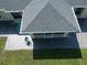Grey asphalt shingle roof and a paved patio with a screened-in porch at 3721 Monday Ter, North Port, FL 34286