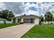 Single-story home with screened-in porch, driveway, and well-maintained lawn at 3721 Monday Ter, North Port, FL 34286